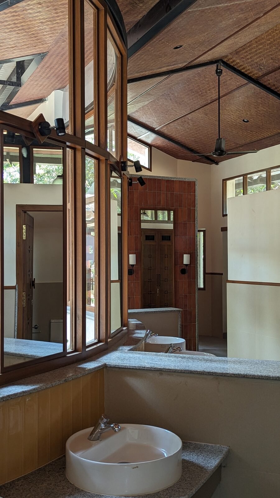 Steel-framed corridor with a freestanding wash basin