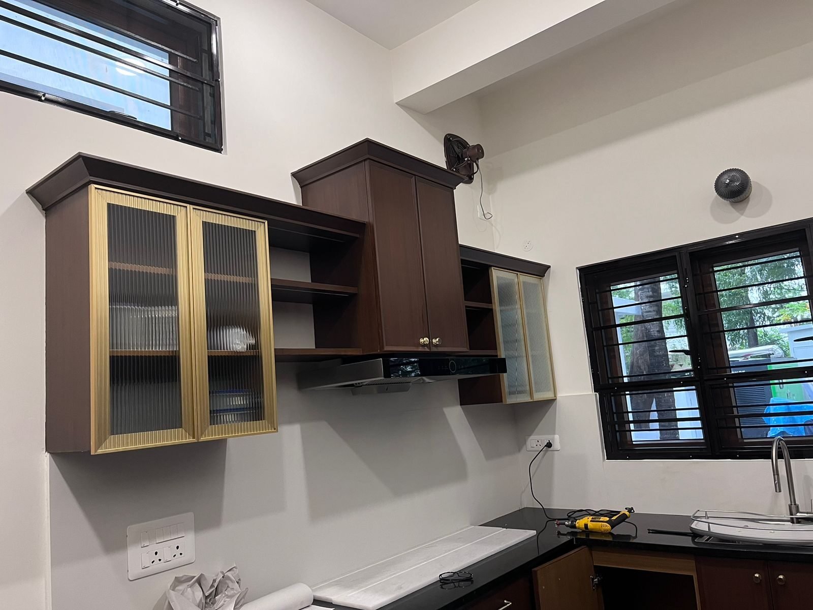 Rosewood-finished kitchen cabinetry with gold trim detailing
