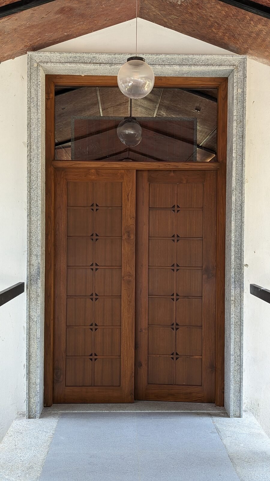 Teak panelled restaurant entrance beneath a brick vaulted ceiling
