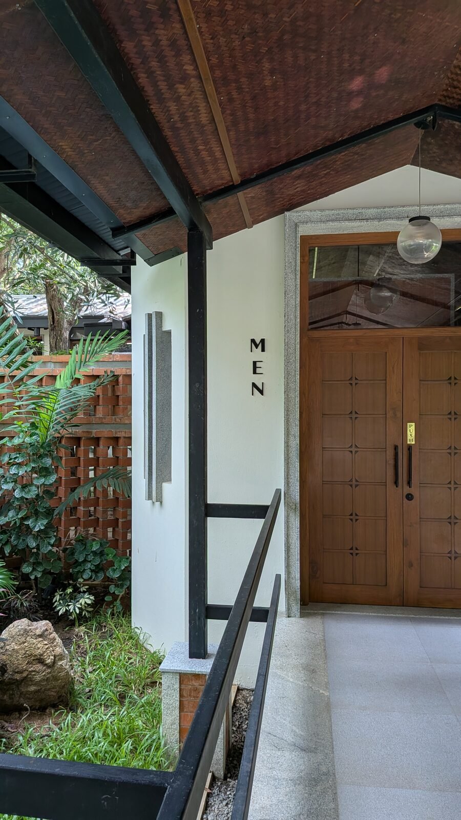 Restroom corridor opening onto a garden view