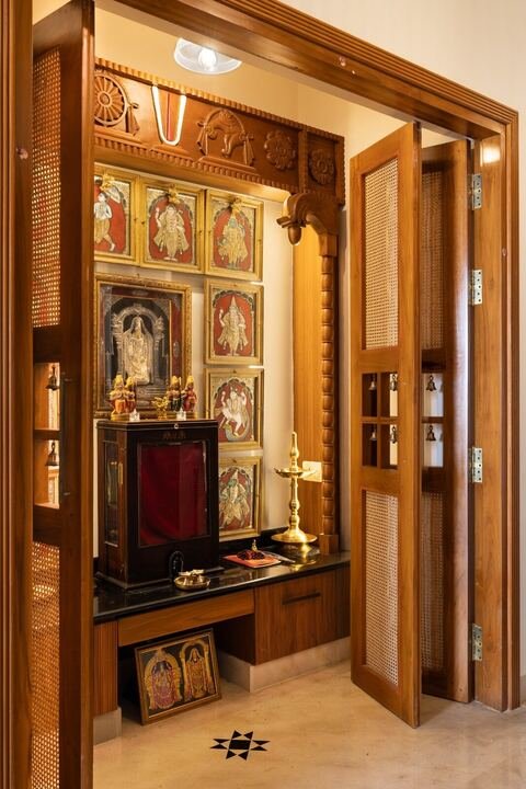 Ornate temple-inspired teak pooja unit with gold detailing